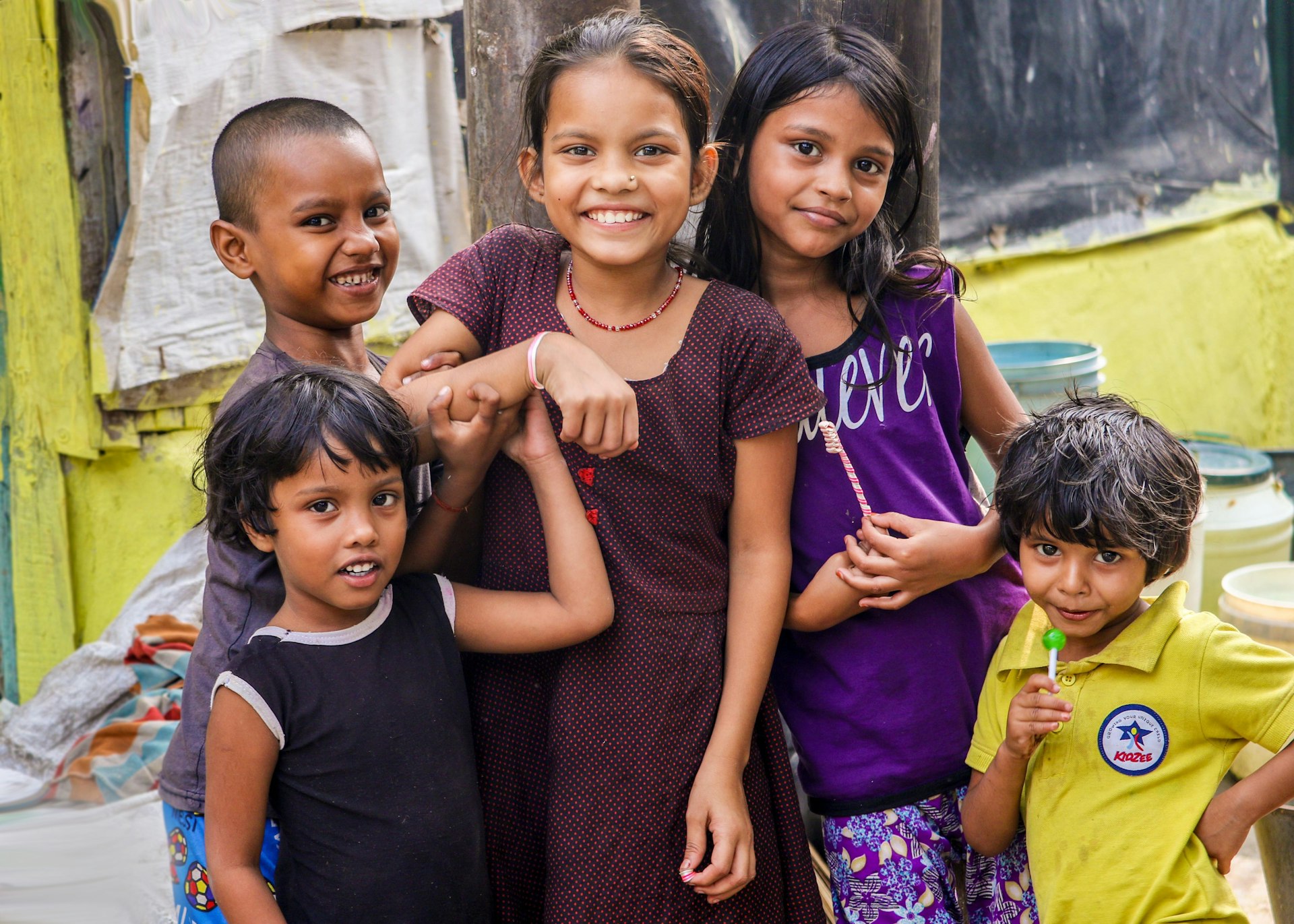Smiling children in a community supported by outreach work
