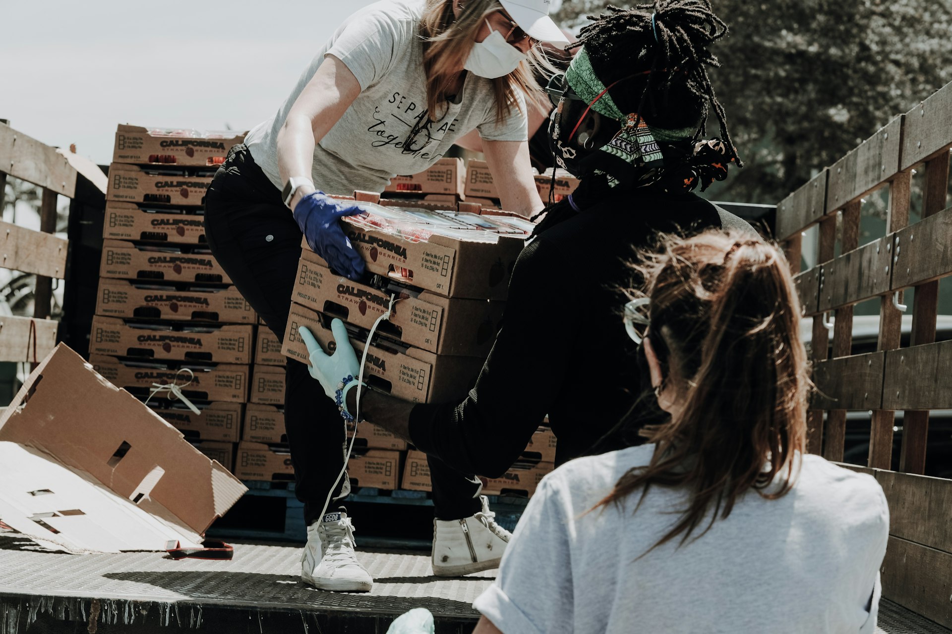 Volunteers handing over supplies at a community distribution